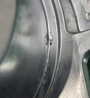 Fig. 2: Die-cast component with delaminations in the sealing edge area 